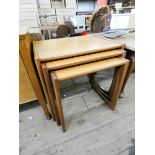 A nest of three teak coffee tables