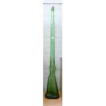 A large green glass bottle in the shape of a musket