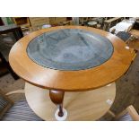 A 1970's circular teak coffee table on cabriole legs with an inset Islamic plaque with a glass top