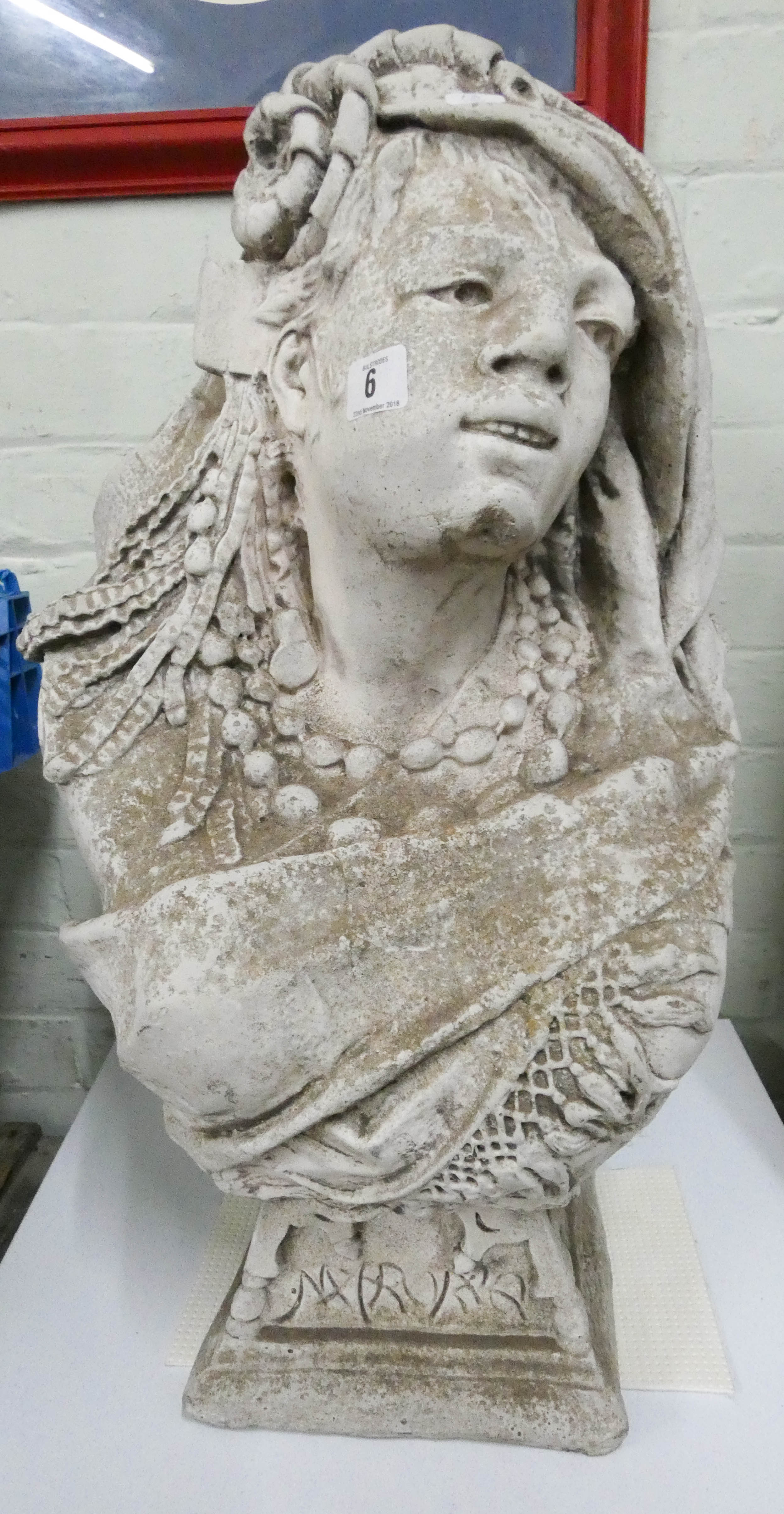 A reconstituted stone of a bust of a young lady