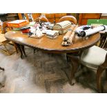 A late Victorian oval mahogany extending dining table with two centre leaves standing on cabriole