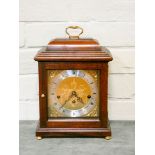 A Georgian style Westminster chiming bracket clock in mahogany case with brass and silver dial