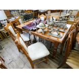 A modern pine farmhouse style dining table on turned legs together with six chairs with cream