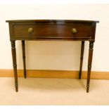 A Georgian style mahogany bow front hall or side table fitted one long drawers on turned tapered