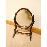 A small Georgian style oval dressing table mirror in mahogany