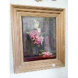 L H Woollatt - A gilt framed still life oil painting of a vase of flowers,