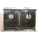 A pair of small black ebonised Chinese two door cabinets Approx height 28",
