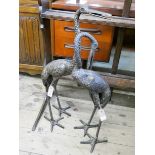 A pair of bronze effect cranes garden ornaments,