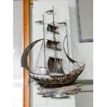 A metal galleon wall plaque