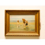 An oil on board study of four children paddling on the seashore indistinctly signed N Franks,
