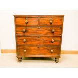 A early Victorian mahogany chest of three long and two short drawers with bun handles standing on