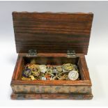 Various military and enamel badges in an old pine cigarette box