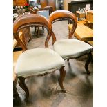 A set of six Victorian mahogany hooped back dining room chairs on cabriole legs with pale green