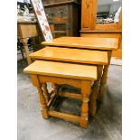 A nest of three reproduction light oak coffee tables