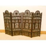 An oriental carved two section four fold fire screen