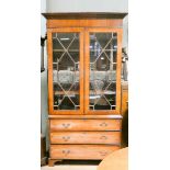 A Georgian style mahogany lattice glazed two door bookcase standing on base fitted three long