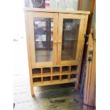 A light beech two door glazed display cabinet with wine racks under and inset marble top 27 1/2"