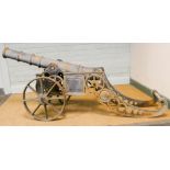 A heavy replica iron cannon on wheels,