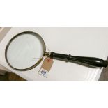 A large hand held magnifying glass approx 6" diameter