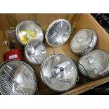 Approximately seven old car spotlights