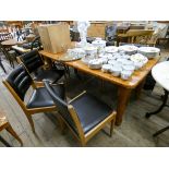 A large modern pine farmhouse style dining table together with six chairs with black vinyl seats