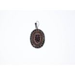 19th century oval Bohemian garnet pendant set in white metal unmarked probably silver,