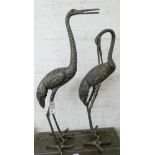 A pair of bronze effect cranes garden ornaments,