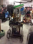 Lot contains portable cut and weld outfit with torch, regulators, hose, and cart; and a lot of assor