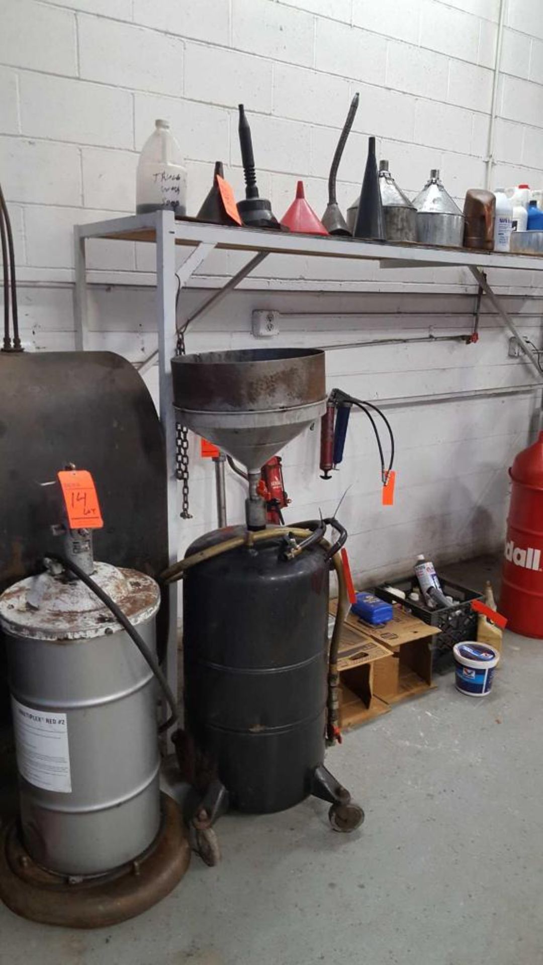 Lot contains (1) portable lube unit, (8)assorted funnels, (1) portable collection tank, (2) pumps, (