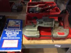 Lot includes one Milwaukee portable electric band saw, cat no 6275, with extra, new blade, and one M