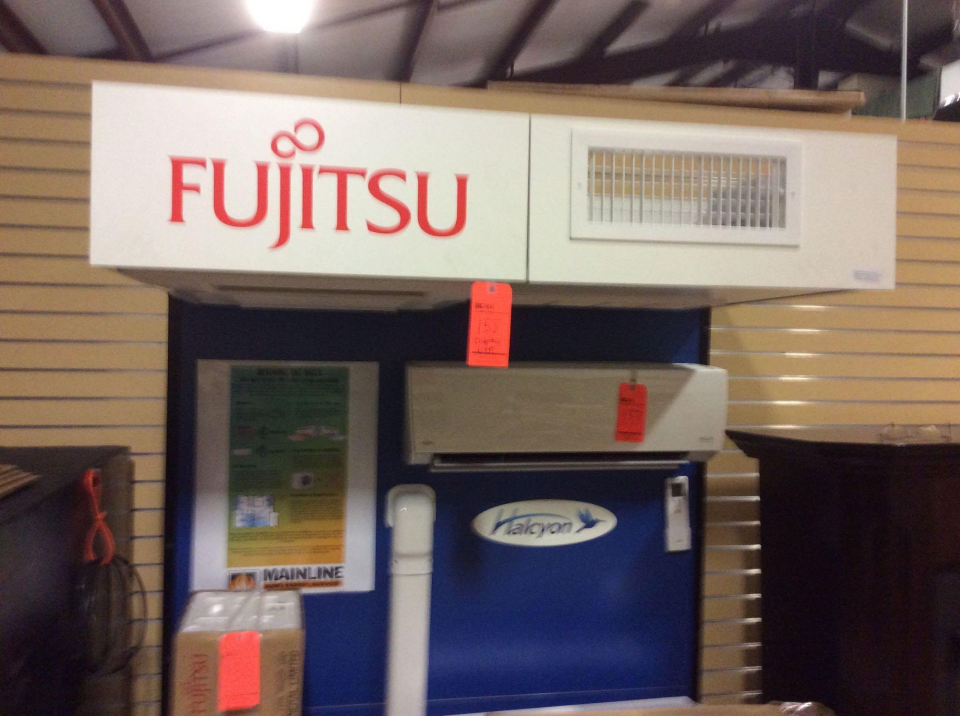 Fujitsu ceiling cassette vent fan model number AUU7RLF, serial number MVA002507, with display stand