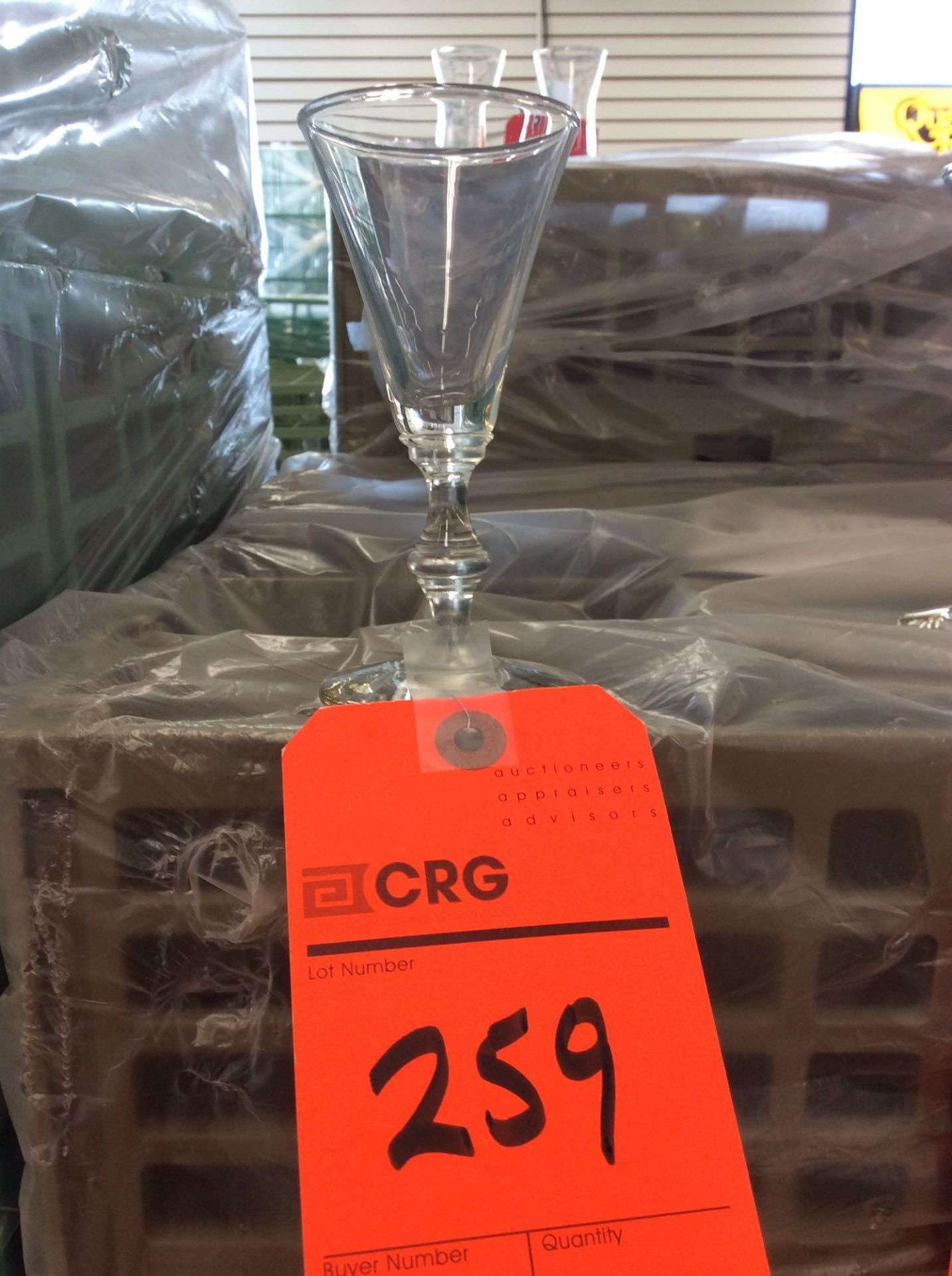 Lot of (263) 2 oz sherry glass with (8) racks, add'l $8 fee per rack