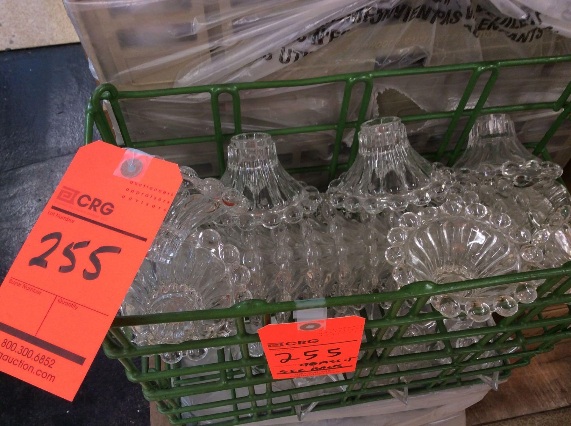 Lot of (90) glass star style candle holders with (4) racks, add'l $8 fee per rack