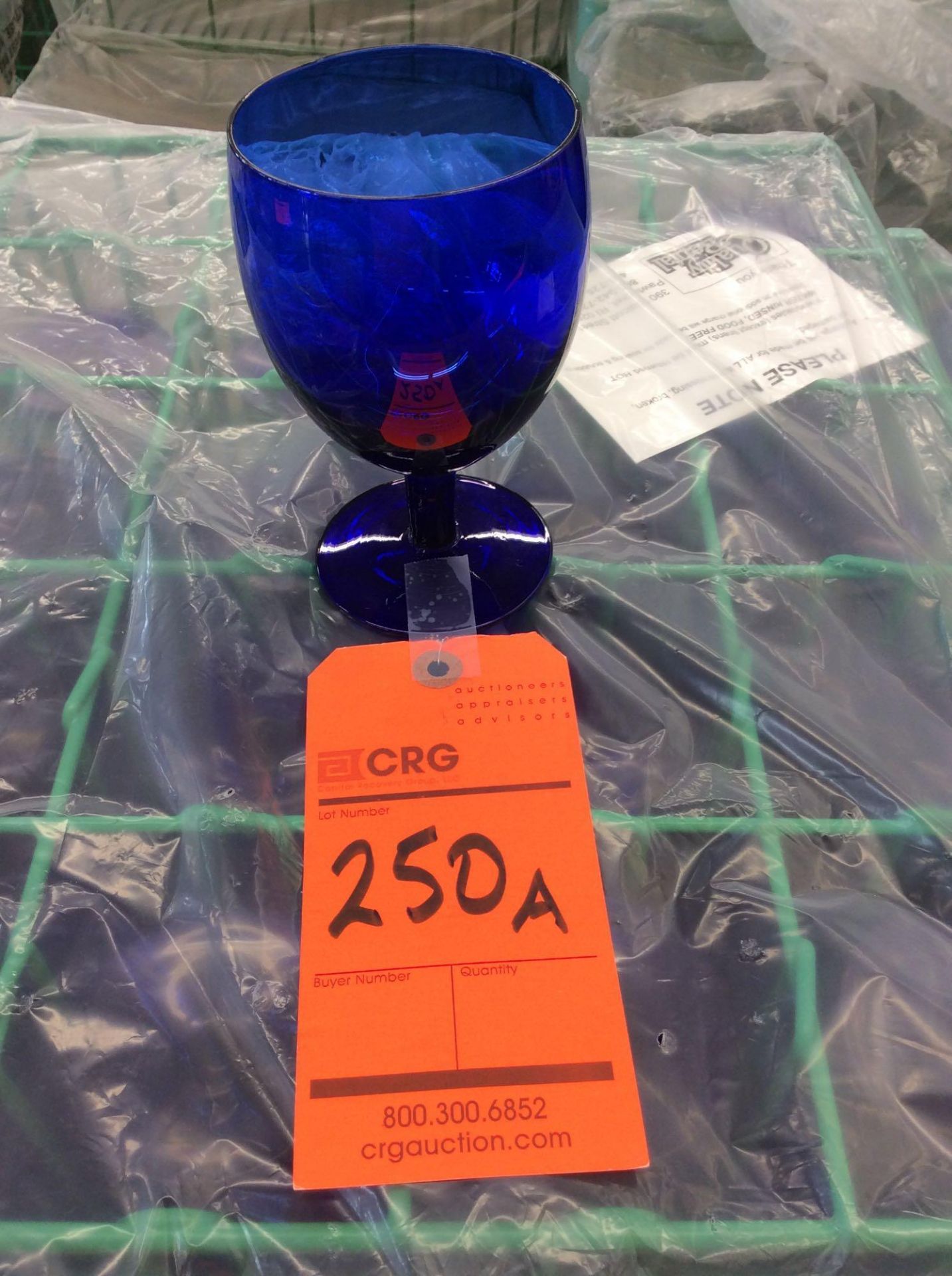 Lot of (121) blue glass all purpose goblet with (5) racks, add'l $8 fee per rack