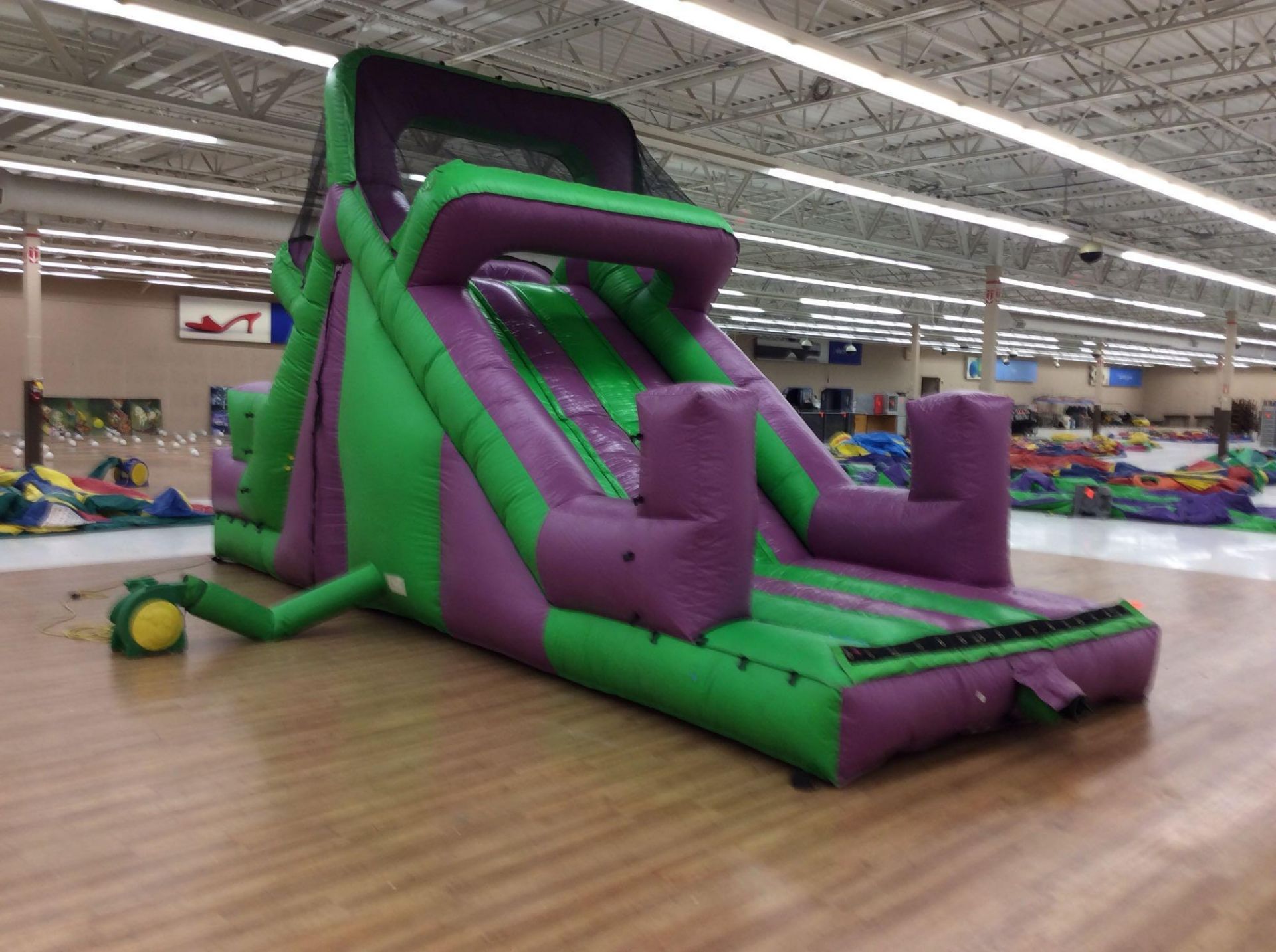10' x25' inflatable purple and green slide with blower. Can be used in conjunction with lot 217,