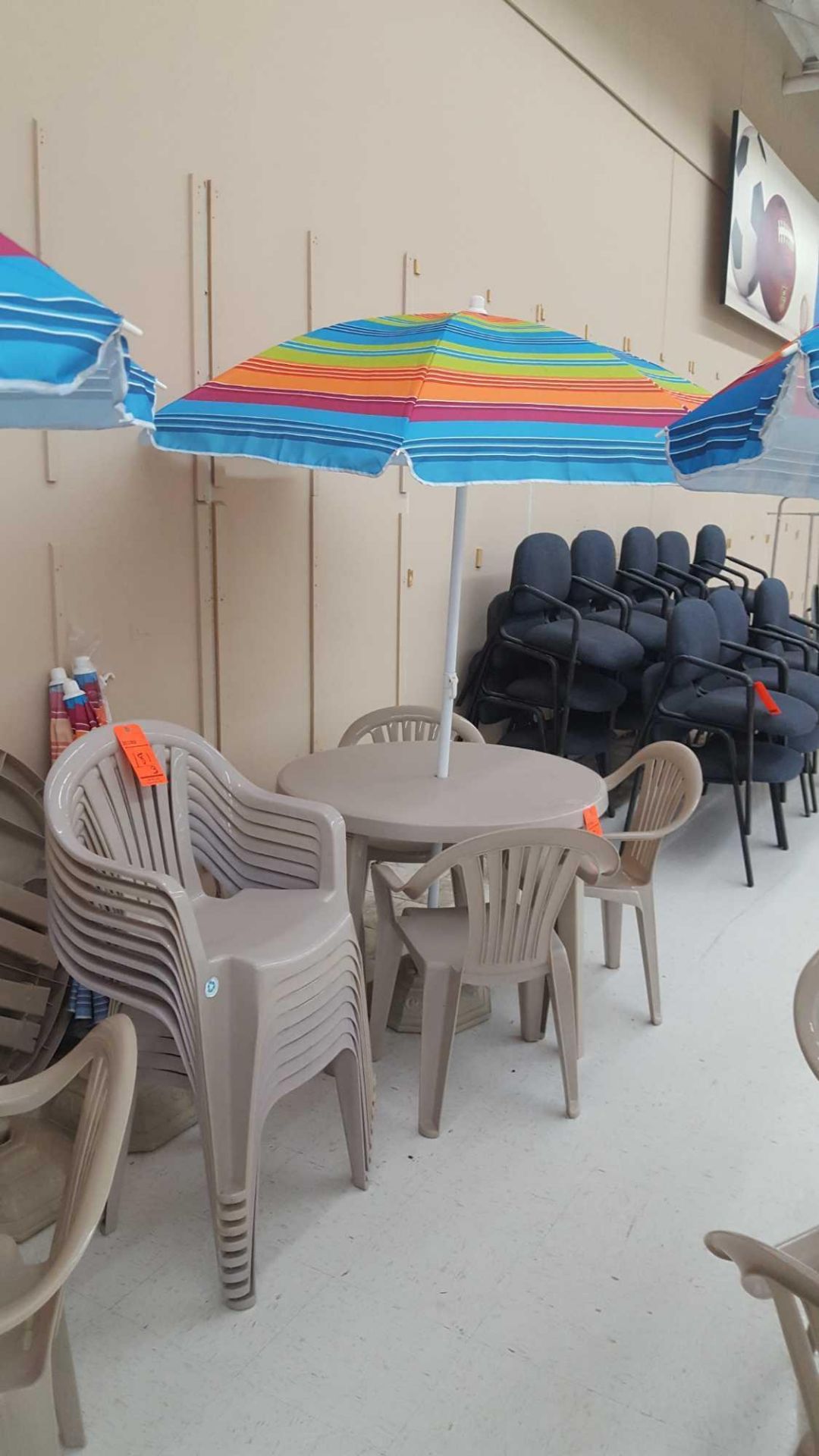 Patio furniture lot - includes (3) resin tables, (12) resin stacking chairs, (3) umbrellas, and (
