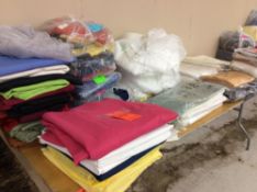Lot of asst linens on table - varied sizes and colors - mostly tablecloths