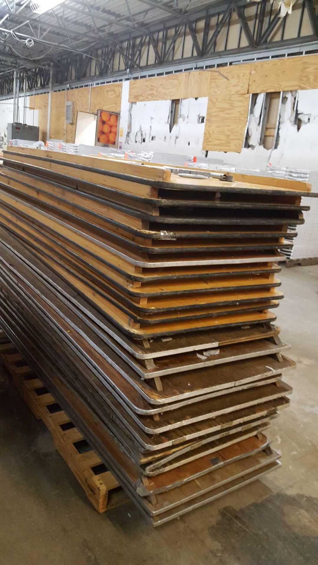 Lot of (24) assorted 8 foot by 30 inch wood tables with folding legs on a pallet - Image 4 of 4