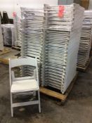Lot of (50) white resin folding chairs on a pallet