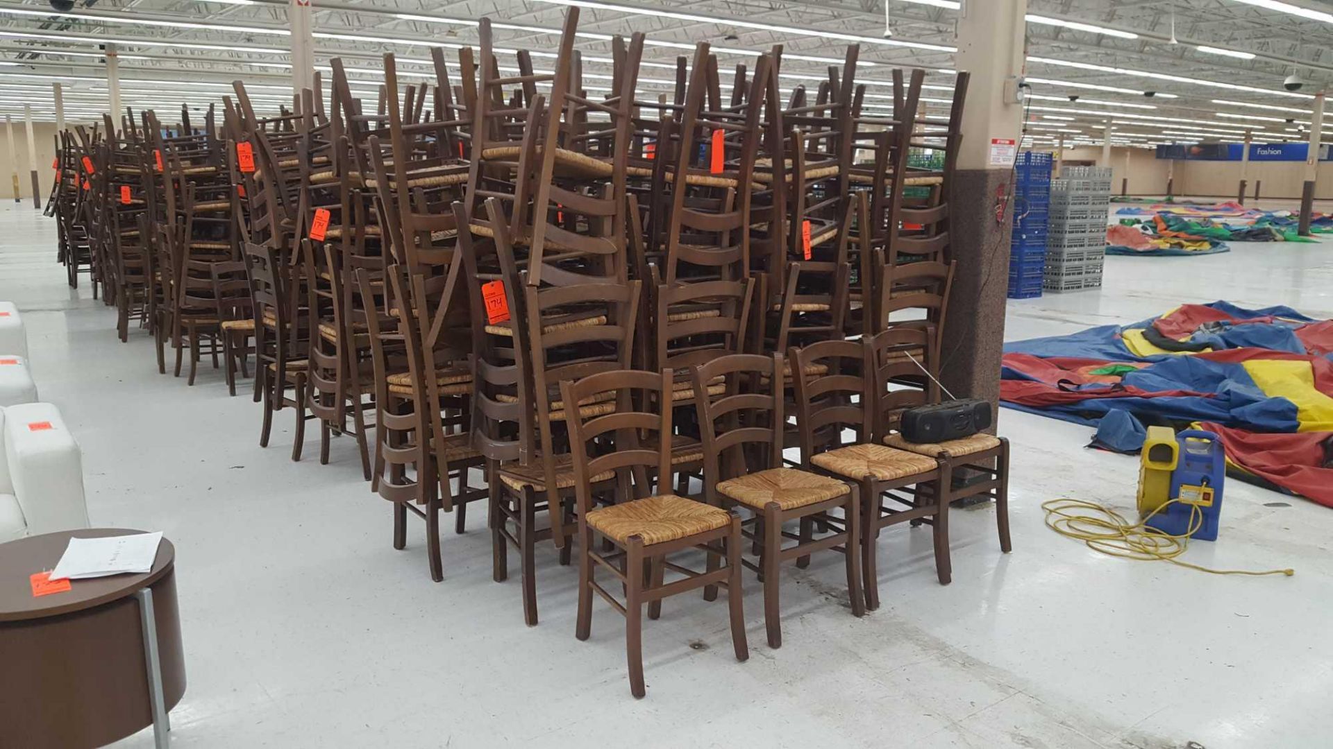 Lot of (100) assorted brown ladder back chairs with cane seats