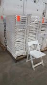 Lot of (50) assorted white folding resin chairs on a pallet