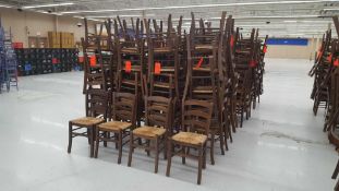 Lot of (140) brown ladder back chairs with cane seats
