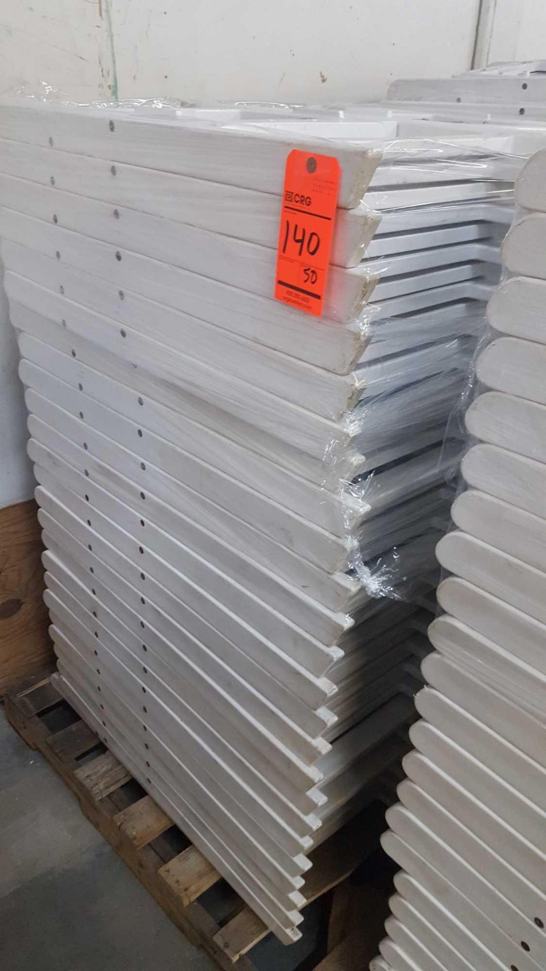 Lot of (50) assorted white resin folding chairs on a pallet