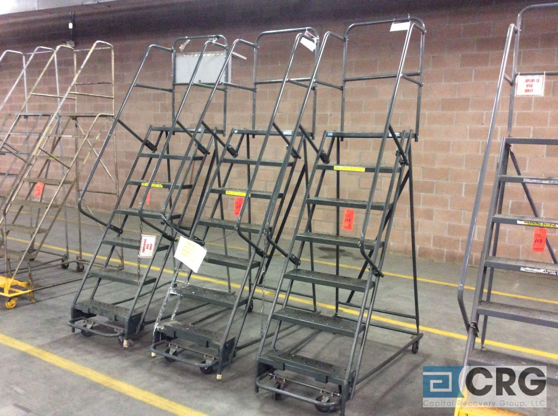 Lot of (3) 7-step rolling steel warehouse stock ladders, approx 6' standing height