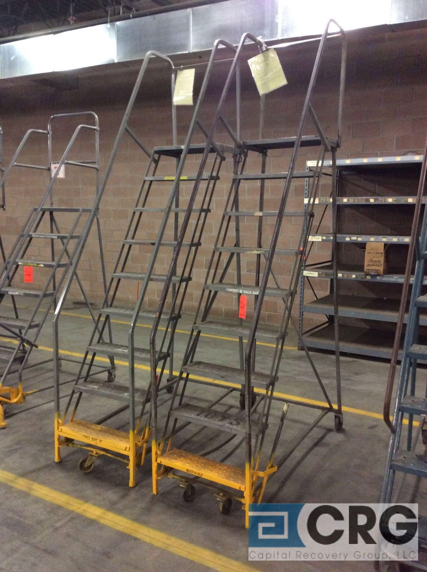 Lot of (2) 9-step rolling steel warehouse stock ladders, approx 7'6" standing heights