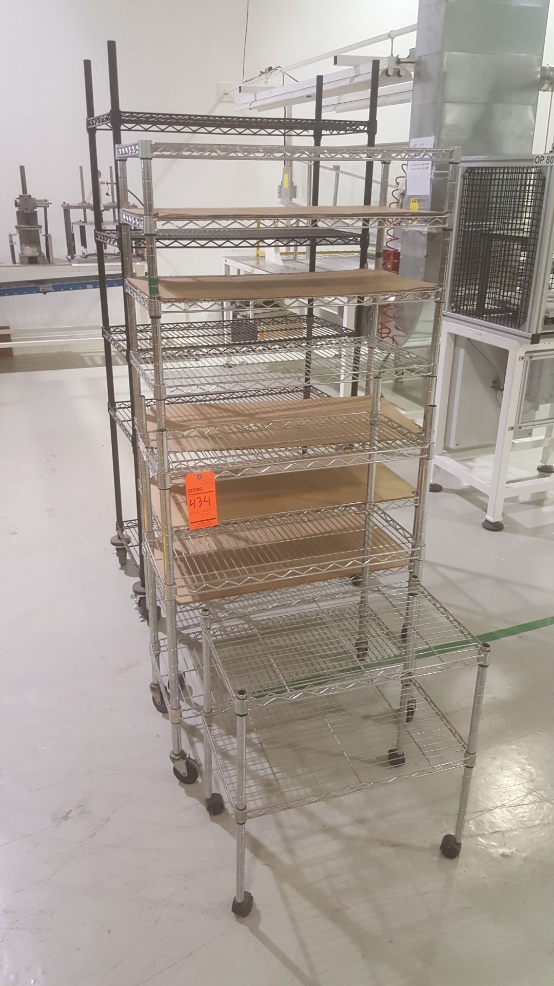 (4) Metal racks w/ adjustable shelving on wheels