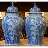 A pair of Chinese vases and covers, decorated dragons, with Dog of Fo finials,
