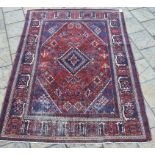 A Persian Meymeh carpet, with red medallion on a multi coloured ground,