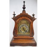 An Edwardian mantel clock, with Arabic numerals, in a walnut case,