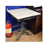 An ebonised marble top tripod occasional table,